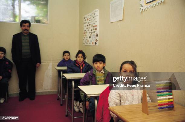 Iraqi School Children and professor in the classroom of a Iraqi school. Madrid