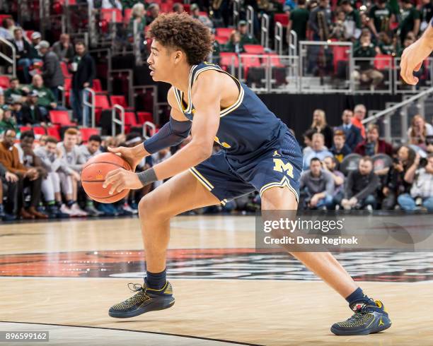 Jordan Poole of the Michigan Wolverines controls the ball against the Detroit Titans during game one of the Hitachi College Basketball Showcase at...