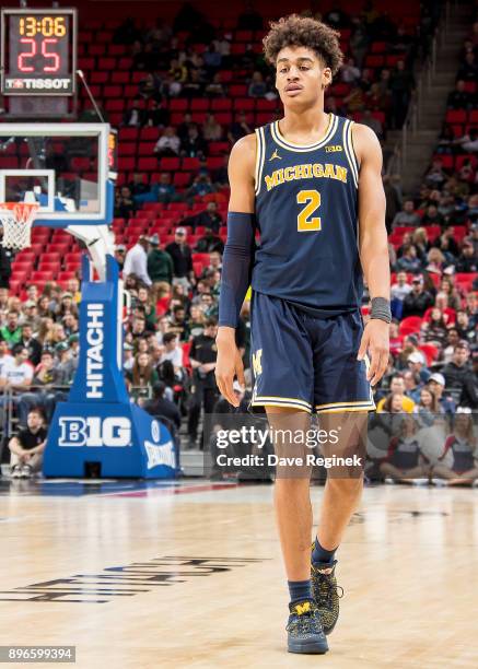 Jordan Poole of the Michigan Wolverines walks up court against the Detroit Titans during game one of the Hitachi College Basketball Showcase at...