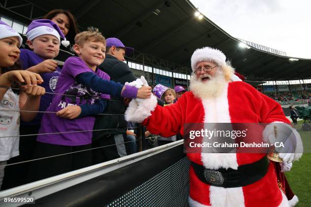 Young fans meet Santa Claus during the Big Bash League match between the Hobart Hurricanes and the Melbourne Renegades at Blundstone Arena on...