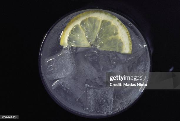 Soda Detail of a lemon slice in a glass with soda and ice cubes