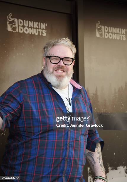 Kristian Nairn AKA Hodor from Game of Thrones holds the door and serves dark roast coffee to welcome winter at Dunkin' Donuts on December 21, 2017 in...