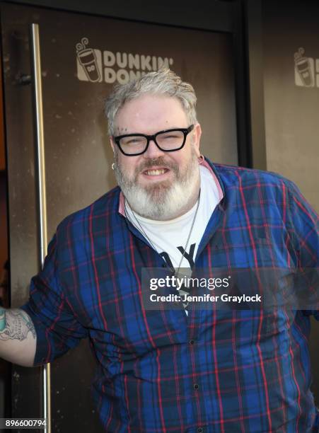 Kristian Nairn AKA Hodor from Game of Thrones holds the door and serves dark roast coffee to welcome winter at Dunkin' Donuts on December 21, 2017 in...