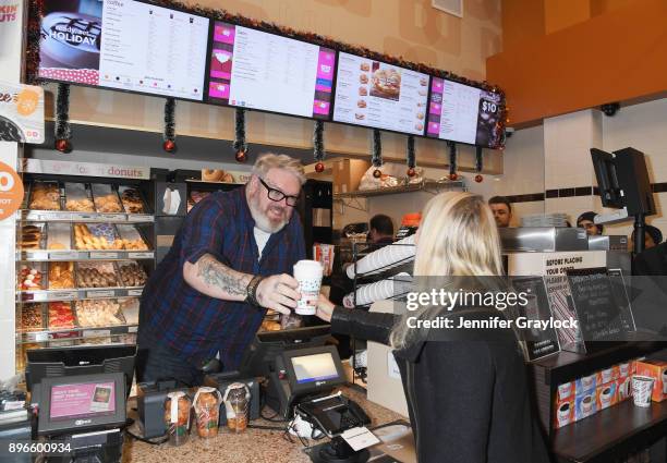 Kristian Nairn AKA Hodor from Game of Thrones holds the door and serves dark roast coffee to welcome winter at Dunkin' Donuts on December 21, 2017 in...