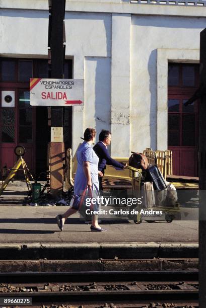 Spanish emigrants in the French vintage Spanish emigrants with suitcases in a platform, behind them, there is a poster with the message: ´Spanish...