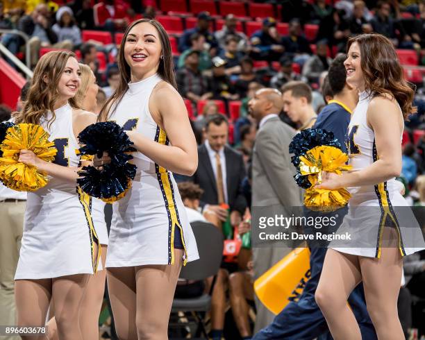 Members of the Michigan Wolverines cheer team entertain the fans on a play stoppage during game one against the Detroit Titans of the Hitachi College...
