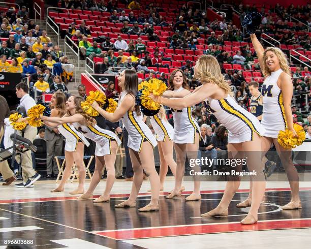 Members of the Michigan Wolverines cheer team entertain the fans on a play stoppage during game one against the Detroit Titans of the Hitachi College...