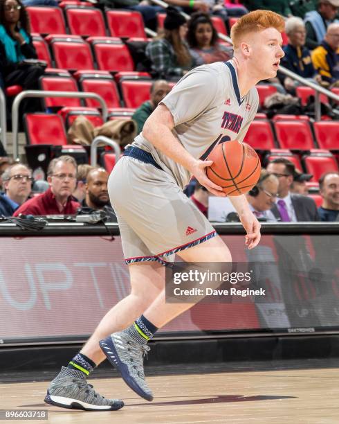 Jack Ballantyne of the Detroit Titans controls the ball against the Michigan Wolverines during game one of the Hitachi College Basketball Showcase at...