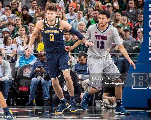 Brent Hibbitts of the Michigan Wolverines follows the play next to Malik Eichler of the Detroit Titans during game one of the Hitachi College...