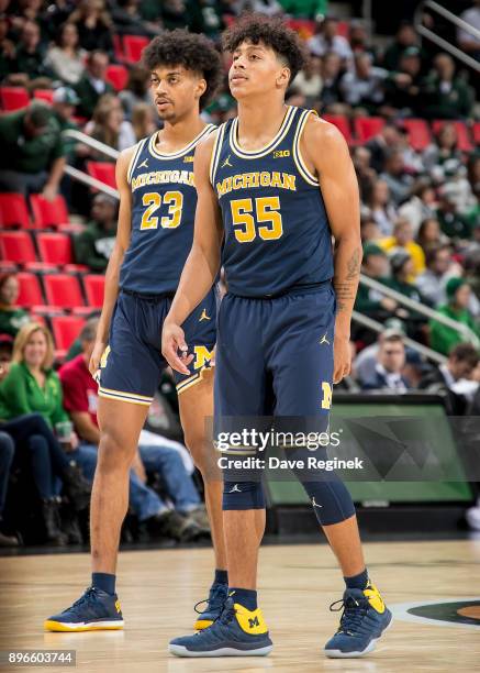 Eli Brooks and Ibi Watson of the Michigan Wolverines follows the play against the Detroit Titans during game one of the Hitachi College Basketball...