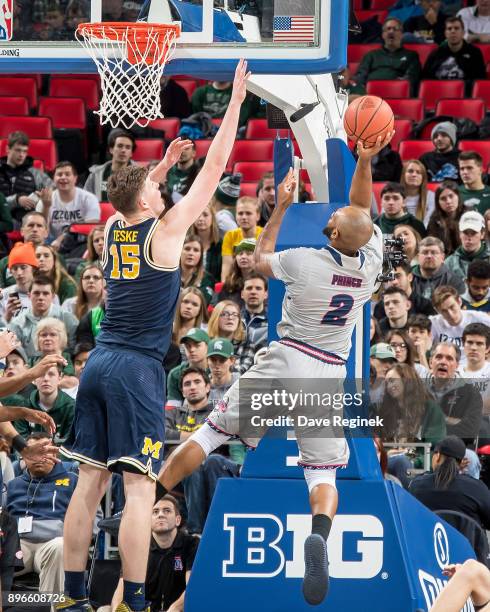 Roschon Prince of the Detroit Titans drives to the basket on Jon Teske of the Michigan Wolverines during game one of the Hitachi College Basketball...