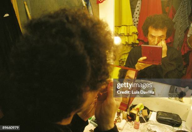 Flamenco dancer in a dressing room Flamenco dancer making himself up in front of the mirror in the dressing rooms of the Corral de la Moreria