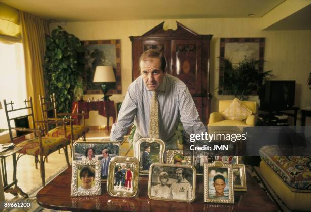 Jose Maria Garcia, journalist In the living room of his house with several family photos