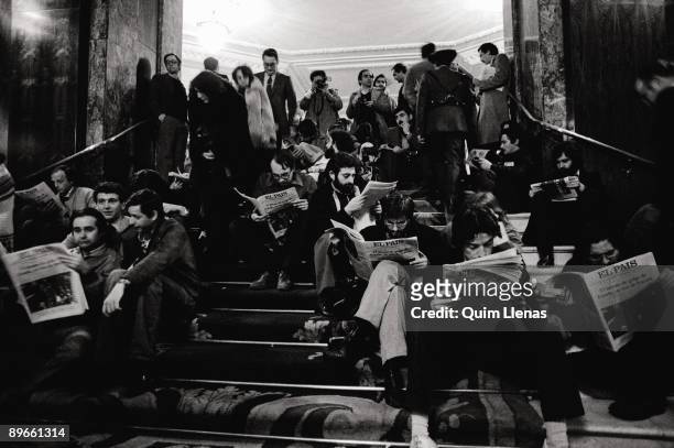 Coup d´Etat Journalists and photographers reading the newspaper ´El Pais´ on the stairs of the Palace Hotel in the night of the Coup d´Etat....