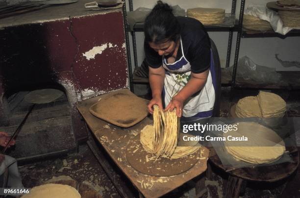 Woman making bread A woman prepares bread carasao in an artisan oven of Cerdena