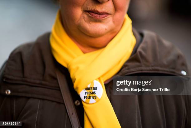 Supporter of jailed Catalan leaders wears pin written "Freedom for political prisoners" talks with some freinds after cast her vote on December 21,...