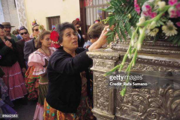 Woman praying in The Rocio A woman prays to the image of the Rocio´s Virgin during the pilgrimage. Huelva province