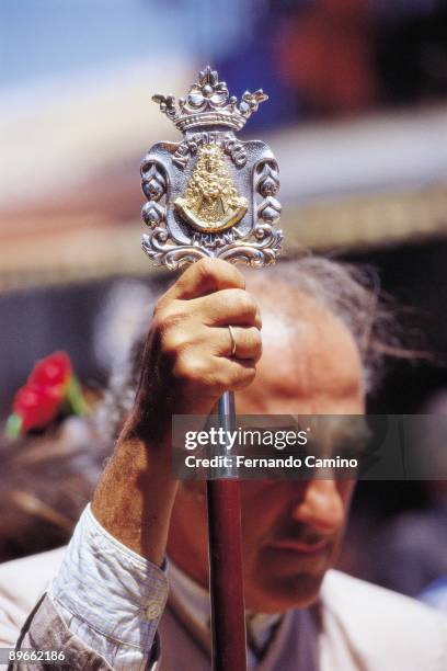 Religious images Man supported in a cane with the Virgin´s image in the Rocio´s pilgrimage. Huelva province