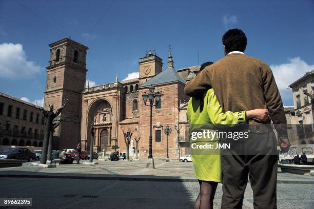 Church of San Andres. ViIllanueva de los Infantes. Ciudad Real A couple of boyfriends, in the Main Square in front of the facade of San Andres´...