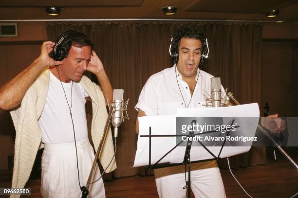 Julio Iglesias and Placido Domingo in a recording studio The singers at a recording take