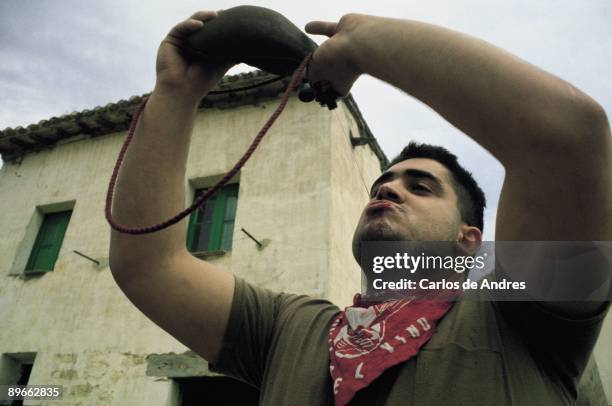 Festivity of the wine, Haro, La Rioja A man drinks wine of a leather bottle during the party of the Wine in Haro