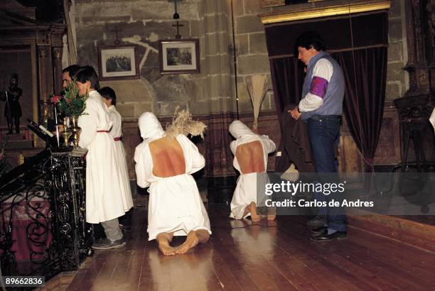 Holy week in San Vicente de la Sonsierra, La Rioja Two ´picaos´ flagellate themselves in a church