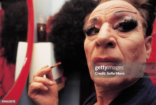 Travestite A travestite puts on makeup and he prepares for the show in a dressing room