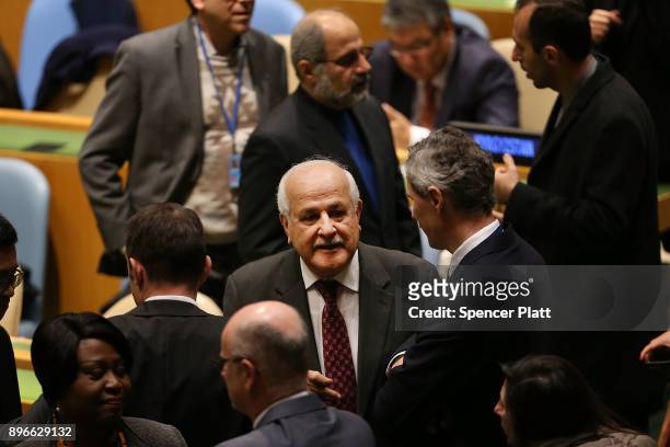 Ambassador Riyad Mansour, Permanent Observer Mission of Palestine to the United Nations, speaks to other diplomats on the floor of the General...