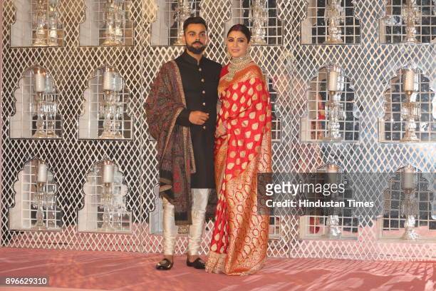 Bollywood actress Anushka Sharma and Indian Cricket captain Virat Kohli pose for photographers during their reception at the Durbar Hall, Taj...