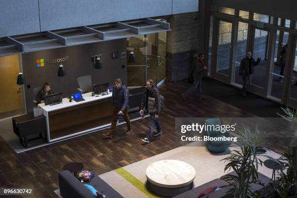 People enter the Studio B building of the Microsoft Corp. Main campus in Redmond, Washington, U.S., on Tuesday, Dec. 19, 2017. In the race to...
