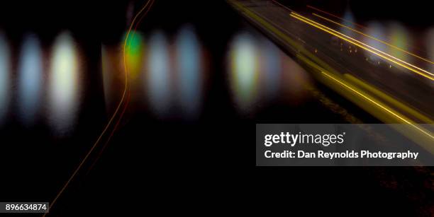 light trails as barge passes under bridge on river - car crash top view stock pictures, royalty-free photos & images