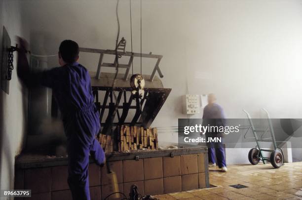 Factory of plugs A worker prepares the boiling of the barks to obtain cork in a factory of plugs . Palafrugell . Gerona province