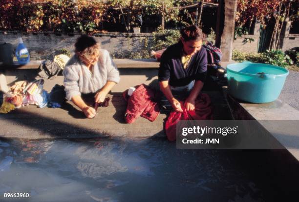 Women washing clothes in a laundry Two women wash their clothes in a laundry of the town of Las Angustias . La Coruna province