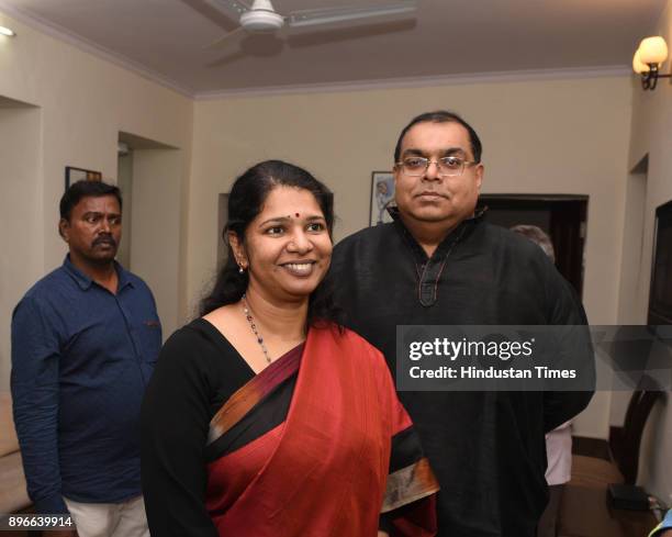 Kanimozhi celebrates with her husband G Aravindan after she was acquitted by a special court in the 2G scam case,while she arrived after court at her...