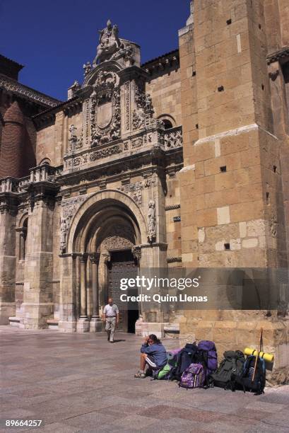 Basilica of San Isidoro. Leon Pilgrims of the Way of Saint James resting to the entrance of the basilica , important monument of the Spanish...