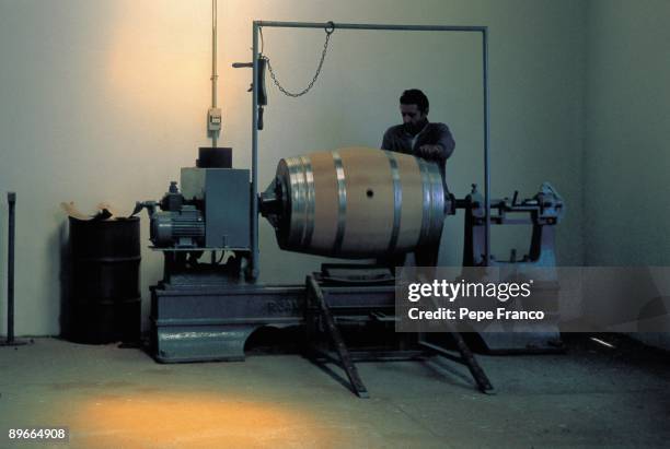 Wine barrels manufacture A man manages a machine in a cooperage of Vega-Sicilia company in the Valladolid province