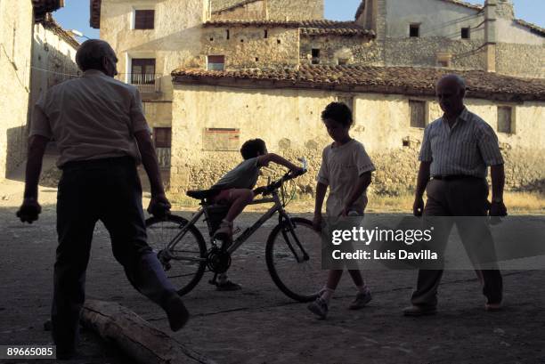 Playing together. Tronchon. Teruel Grandparents and grandsons playing together in the streets of this small town