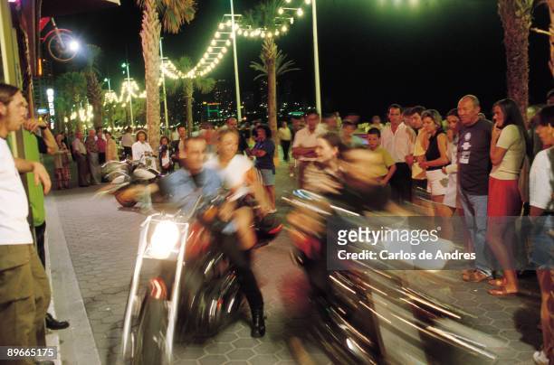 The night of Benidorm. Alicante Night life. Motorists and their machines circulating among people for the Marine Walk