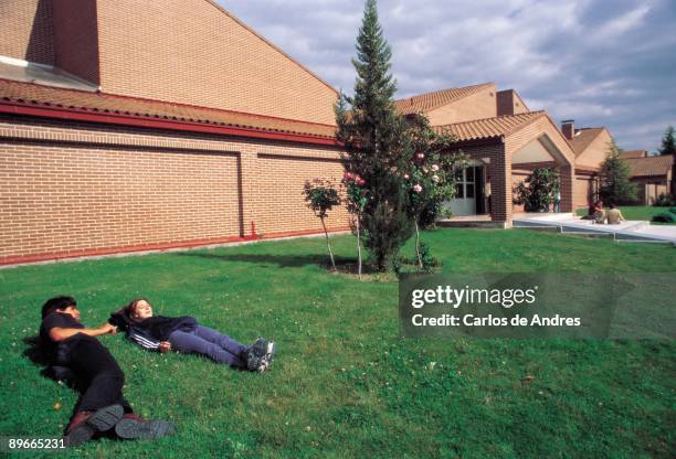 University of Francisco de Vitoria A couple this lying one in the grass of the University of Francisco of Vitoria in Pozuelo de Alarcon. Madrid...