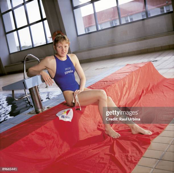 Nina Zhivanevskaia, swimmer Nina Zhivanevskaia sitting next to a swimming pool