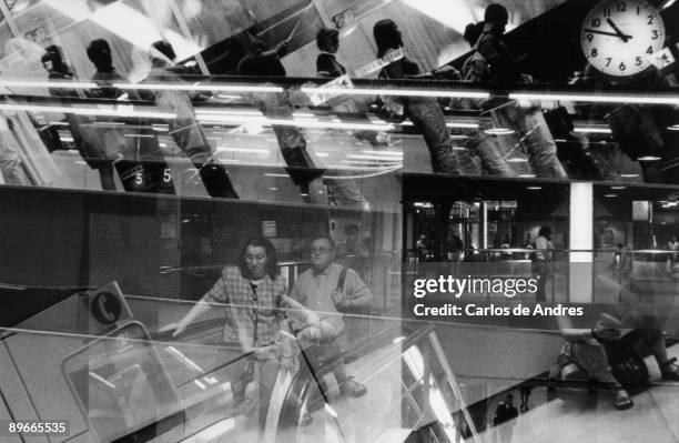 Moncloa subway and bus station People lowering and going up mechanical stairways of Moncloa subway and bus station . Madrid