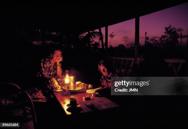 Two women drinking coffee in a porch Two women of Doctors without Frontiers drink coffee in the porch of their house in the district of Nsok Nsomo