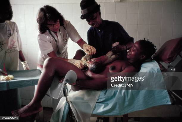 Woman´s childbirth in a surgery theater A woman gives birth to a boy helped by a doctor and a nurse in a surgery theater in the Hospital of Doctors...