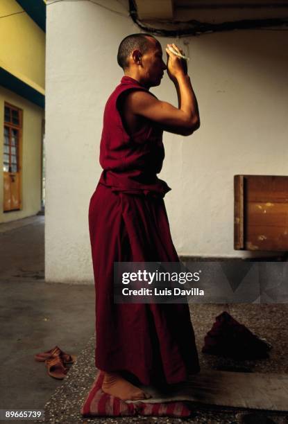 Buddhist monk praying A Buddhist monk prays in the temple and residence of the Dalai Lama in Dharamsala