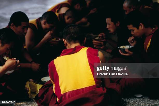 Buddhist monks eating A group of Buddhist monks eats in Dharamsala, temple and residence of the Dalai Lama