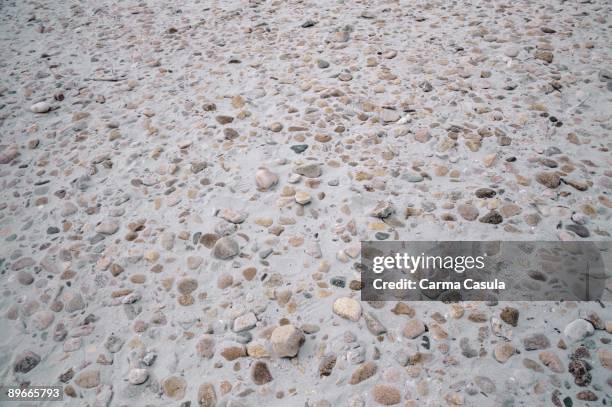 Sand and stones Detail of the stones on the sand of a beach