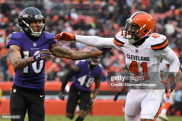 Wide receiver Chris Moore of the Baltimore Ravens engages cornerback Mike Jordan of the Cleveland Browns on punt coverage in the third quarter of a...