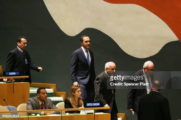 Members of the Palestinian delegation leave the General Assembly hall after a vote on the floor of the United Nations General Assembly in which the...