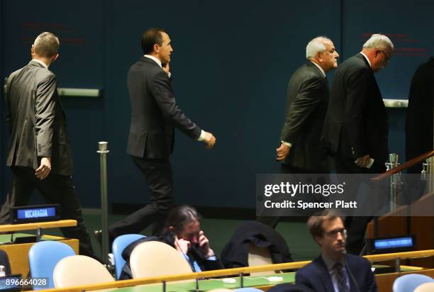 Members of the Palestinian delegation leave the General Assembly hall after a vote on the floor of the United Nations General Assembly in which the...