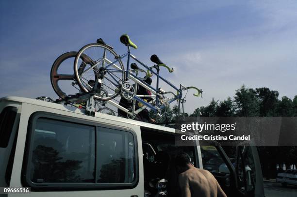 Bicycles on a van Two bicycles tied to the luggage rack of a van in the Casa de Campo Park in Madrid